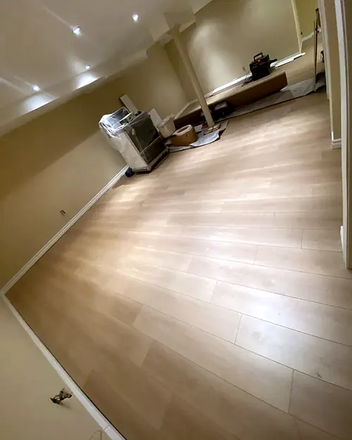 Light laminate plank floor in an empty room