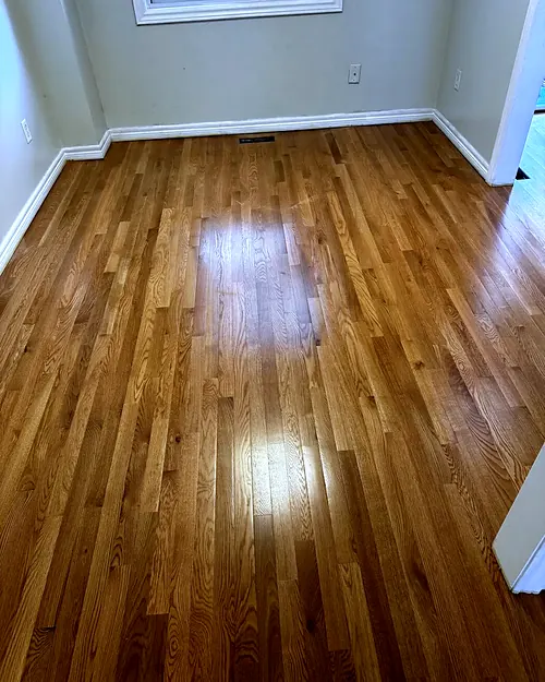 Oak strip floor with a fresh glossy finish in a bright room