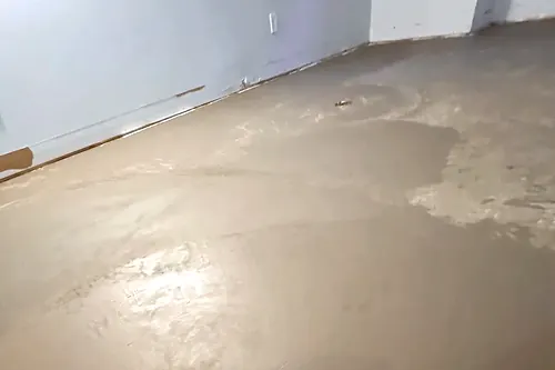 Self-levelling compound poured and set across a room before flooring