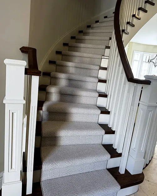 Straight staircase with carpeted treads and white risers